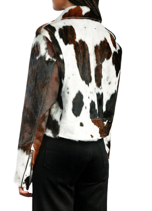 Person wearing a cow print jacket