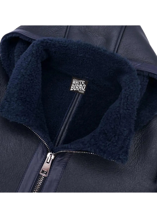 Navy blue jacket with a visible brand logo on the collar against 