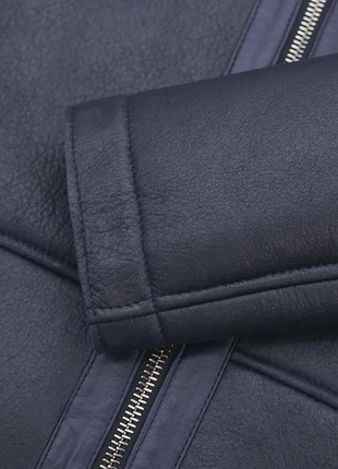 Close-up of a dark blue jacket with zipper details