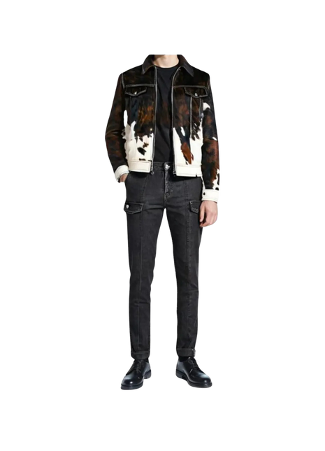 Person wearing a cow print jacket and black jeans 