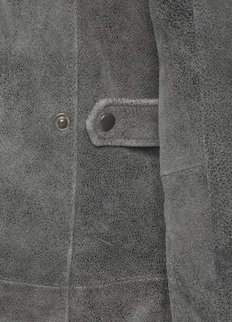 Close-up of a textured gray fabric with a button and stitching detail.