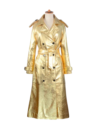 Gold trench coat on a mannequin against 