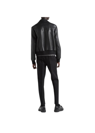 Person wearing a black leather jacket and pants