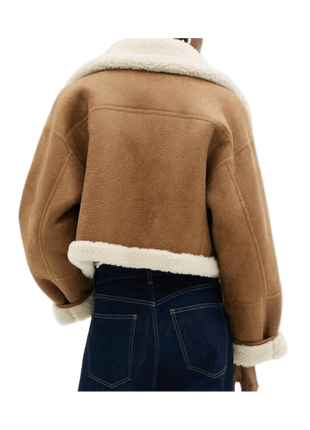 Brown jacket with white fur lining worn by a person