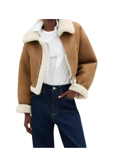 Brown shearling jacket with white trim worn by a person 