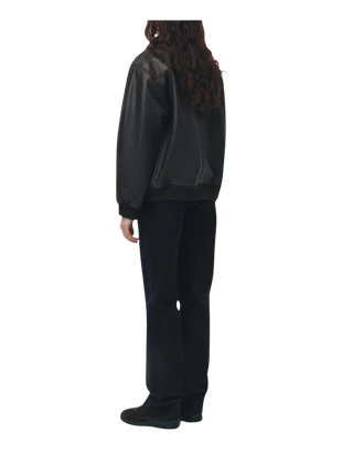Person wearing a black raincoat and pants 