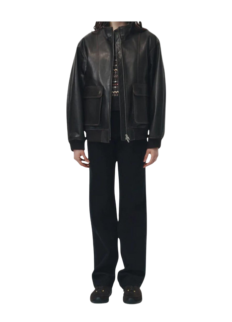 Person wearing a black leather jacket and pants 