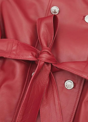 Close-up of a red leather jacket with a tie waist 