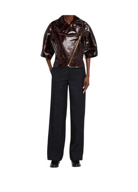 Brown leather jacket with gold zipper and black pants 